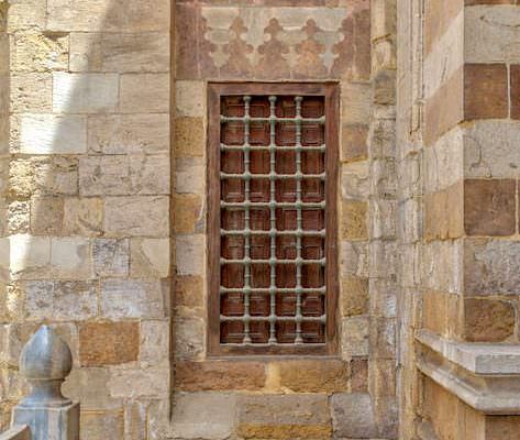 Window with iron bars on exterior stone bricks wall of Amir Aqsunqur Mosque (Blue Mosque)